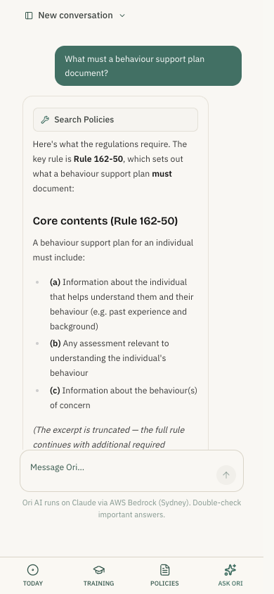 The OriComply staff app on a phone: a care worker asks what a behaviour support plan must document, and Ori answers with the rule and a link to the matching policy